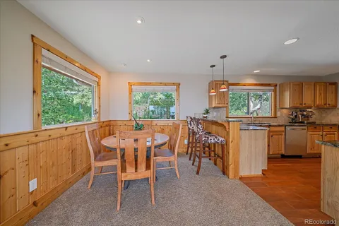 a view of a dining room with furniture window and outside view