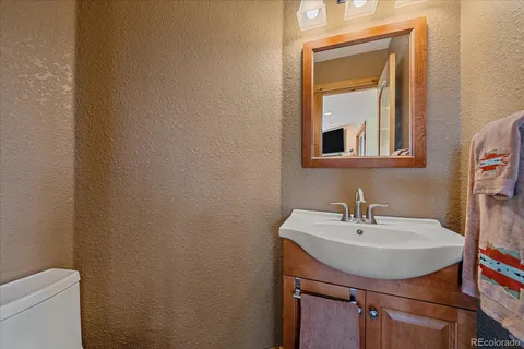 a view of a balcony with wooden floor and outdoor seating