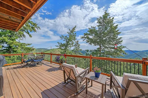 a view of balcony with furniture and wooden floor