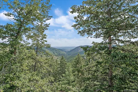 a view of a livingroom with workspace and a window