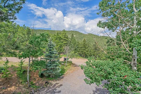 a view of a balcony with wooden chairs