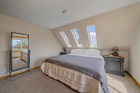 a bathroom with a granite countertop sink a toilet a mirror and a tub