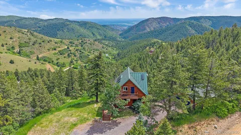 a view of a lush green hillside and a building