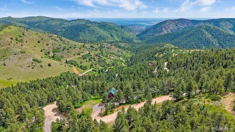 a view of a house with a yard and a tree