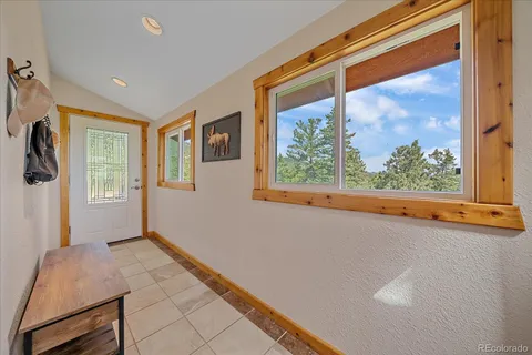 a view of a hallway and a livingroom with furniture