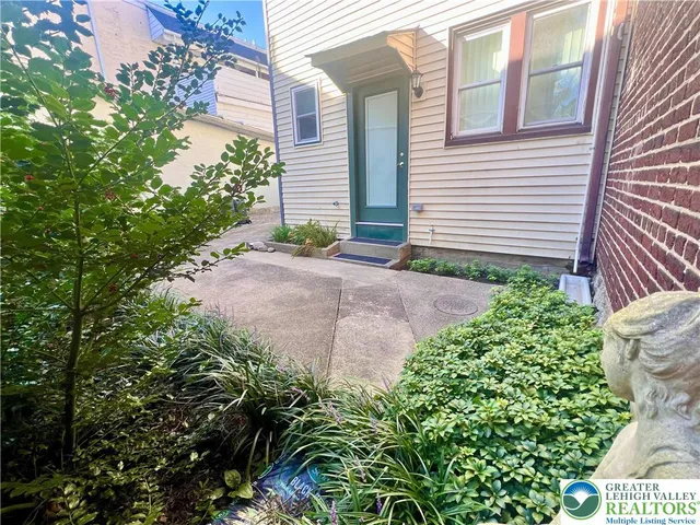 a view of a pathway with a house in front of yard