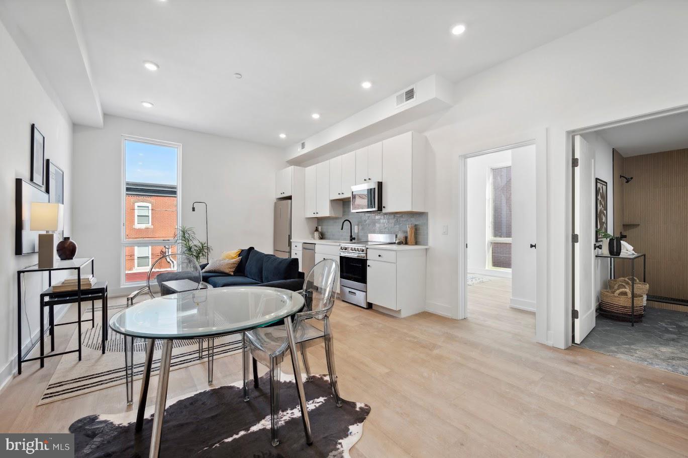 a living room with furniture a dining table and kitchen view