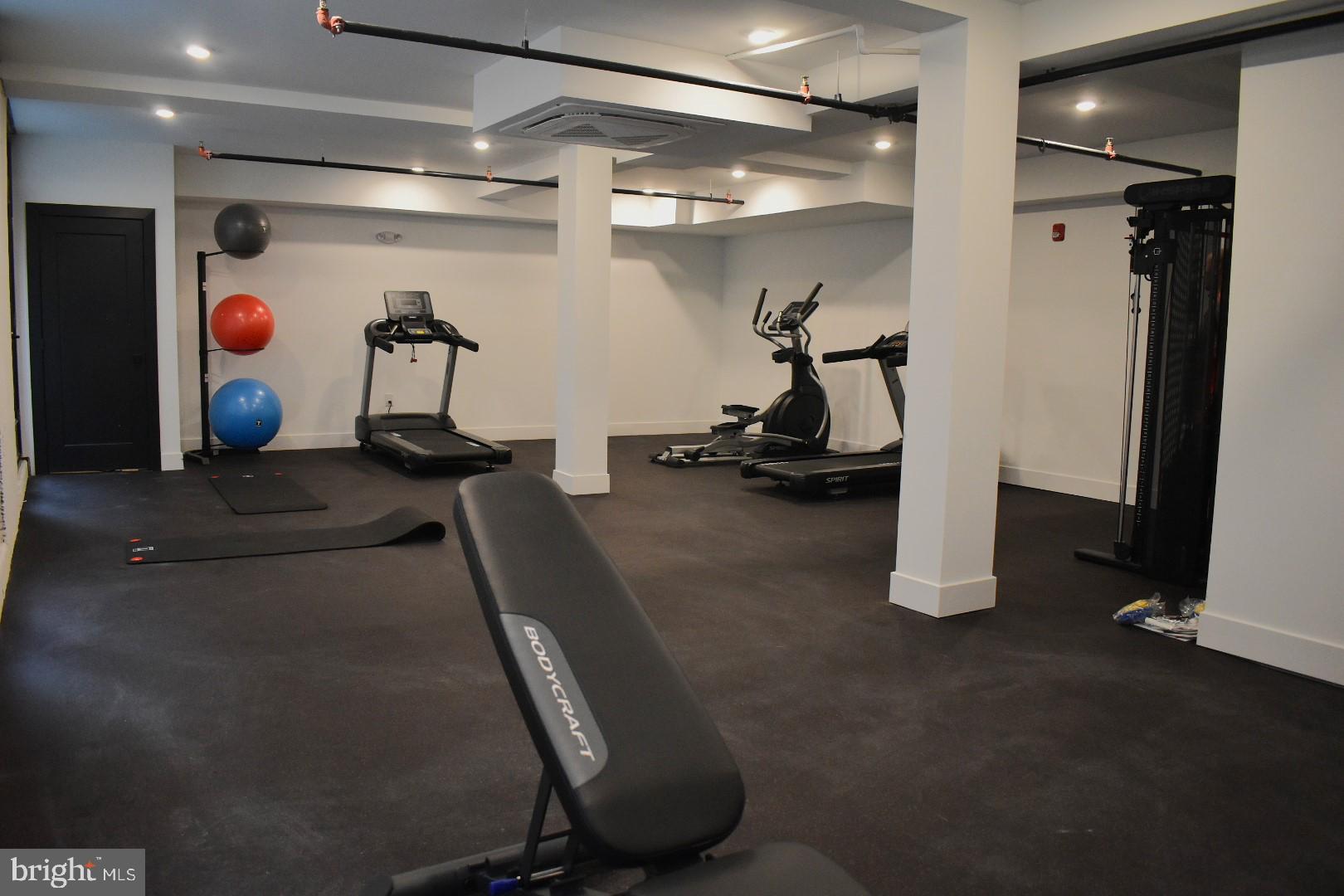 3037 Richmond Street, Unit 107 Philadelphia, PA 19134 - Photo 13 of 15 a room with gym equipment and white walls
