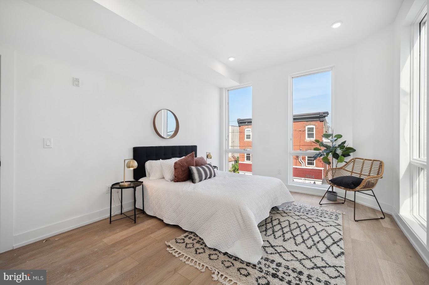 3037 Richmond Street, Unit 107 Philadelphia, PA 19134 - Photo 7 of 15 a bed room with a bed and a chair