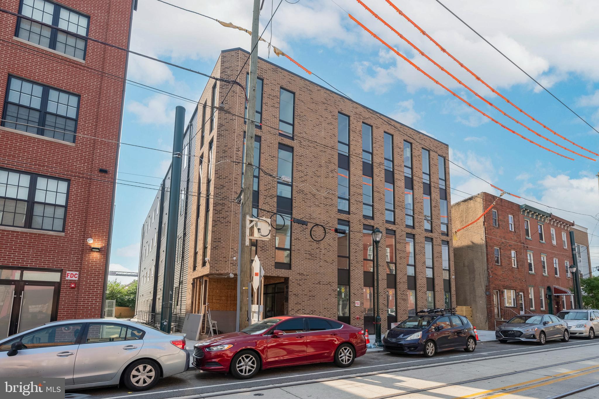 3037 Richmond Street, Unit 107 Philadelphia, PA 19134 - Photo 8 of 15 a car parked in front of a building