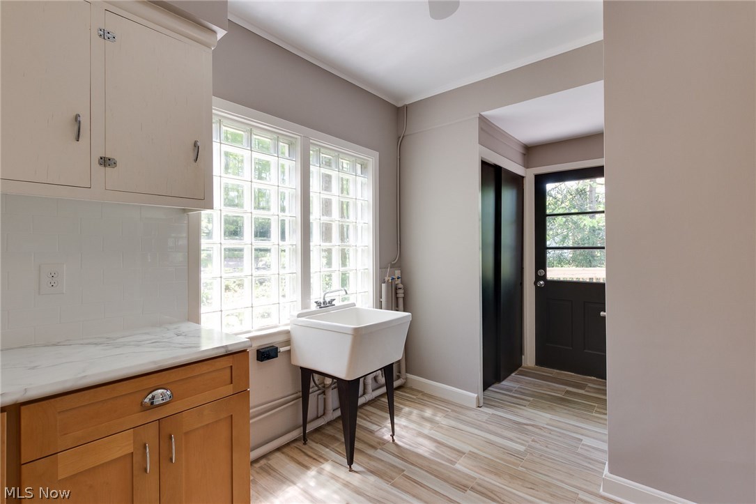 1046 Allston Road Cleveland Heights, OH 44121 - Photo 16 of 34 Have you ever seen such a bright and light Laundry room! The Kitchen is off to the right. The rear door is the second entry that leads out to the deck. The closet has ample hanging and storage space. And opposite the closet is a delightful half bath!
