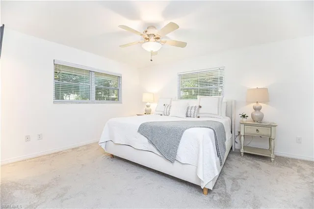 a spacious bedroom with a bed and window