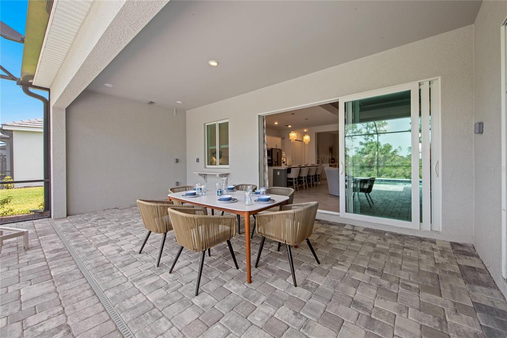 7161 Inlet Isles Lakewood Ranch, FL 34202 - Photo 26 of 29 a view of a dining room with furniture and a potted plant