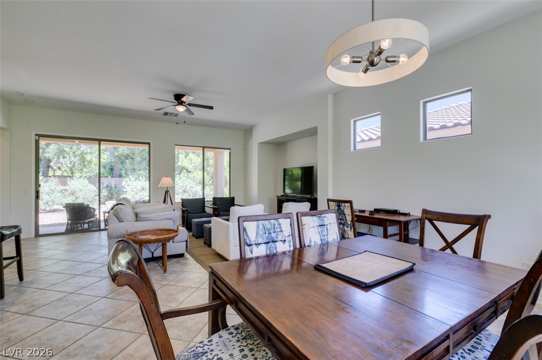 8 Kennesaw Road Henderson, NV 89052 - Photo 7 of 44 An open-concept living and dining area features abundant natural light and seamless indoor-outdoor flow.