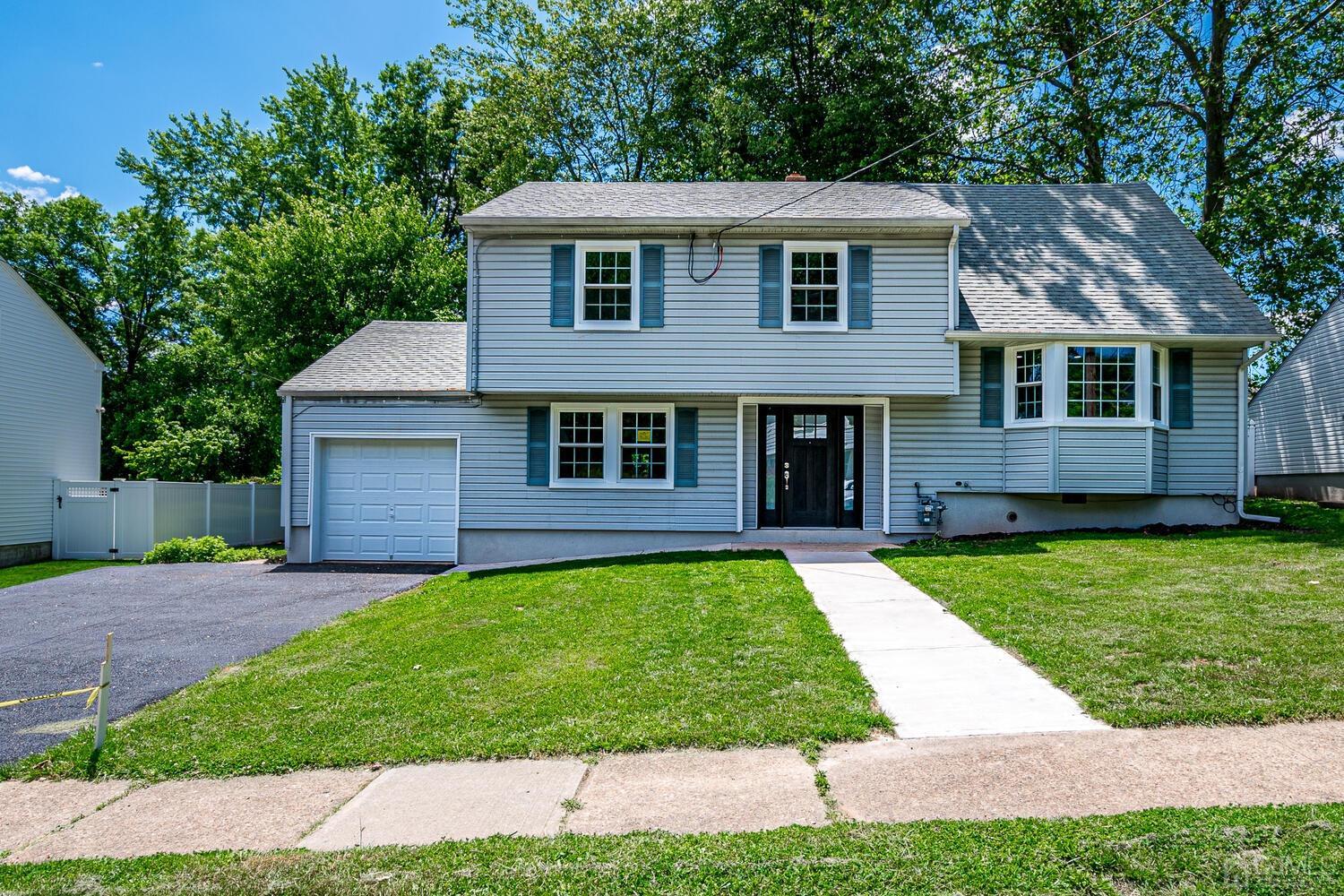 8 Amman Road Edison, NJ 08817 - Photo 1 of 39 a front view of a house with a garden