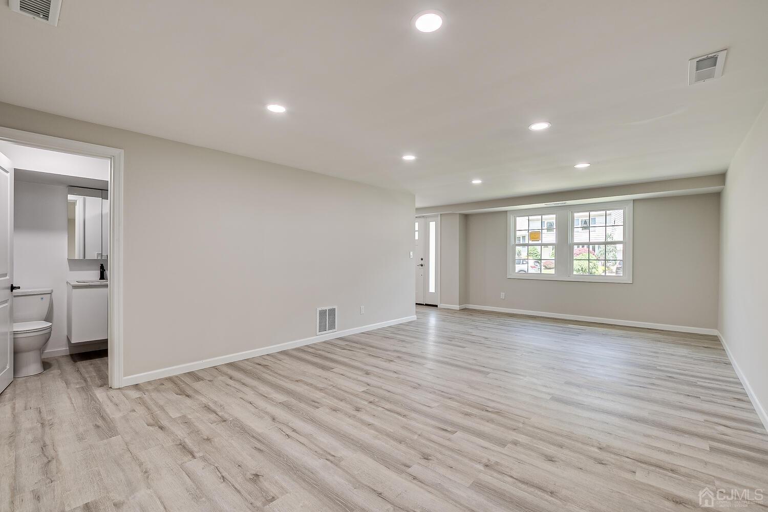 8 Amman Road Edison, NJ 08817 - Photo 11 of 39 wooden floor in an empty room with a window