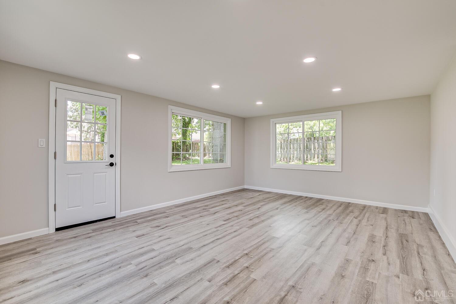 8 Amman Road Edison, NJ 08817 - Photo 13 of 39 an empty room with wooden floor and windows