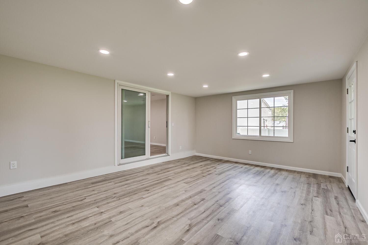 8 Amman Road Edison, NJ 08817 - Photo 14 of 39 a view of an empty room with wooden floor and a window