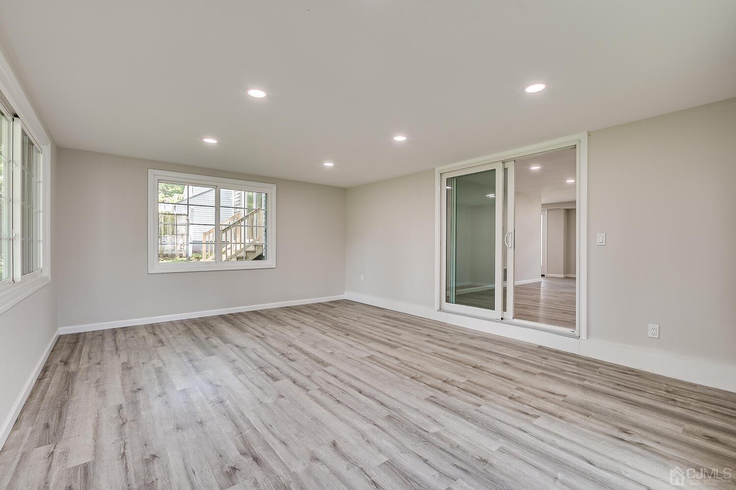 8 Amman Road Edison, NJ 08817 - Photo 15 of 39 an empty room with wooden floor and windows