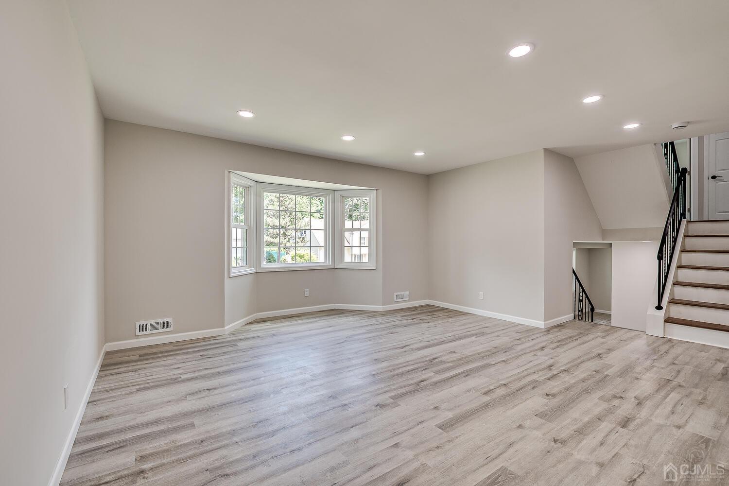 8 Amman Road Edison, NJ 08817 - Photo 16 of 39 an empty room with wooden floor and windows