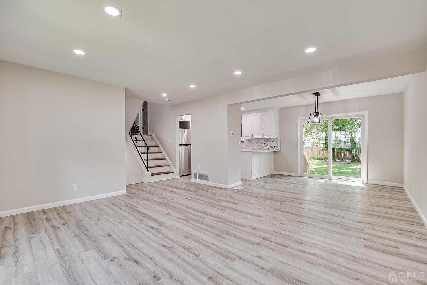 8 Amman Road Edison, NJ 08817 - Photo 17 of 39 a view of an empty room with wooden floor and windows