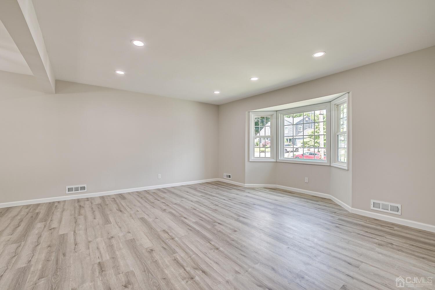 8 Amman Road Edison, NJ 08817 - Photo 18 of 39 an empty room with wooden floor and windows