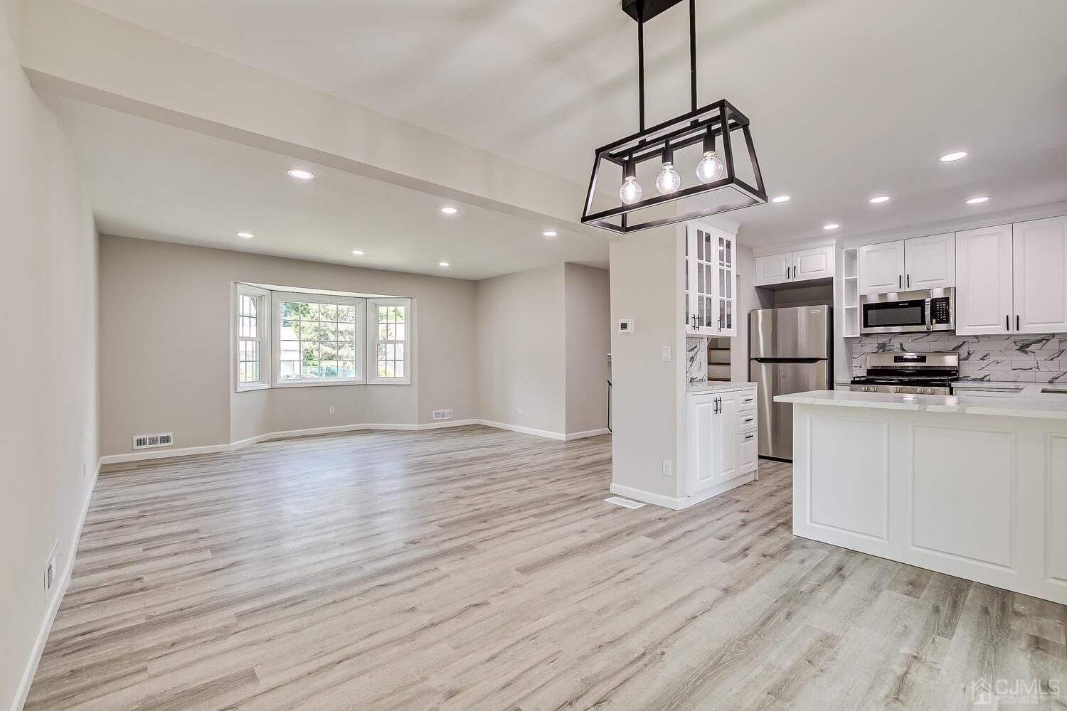 8 Amman Road Edison, NJ 08817 - Photo 19 of 39 a view of a kitchen with wooden floor a sink a refrigerator and window