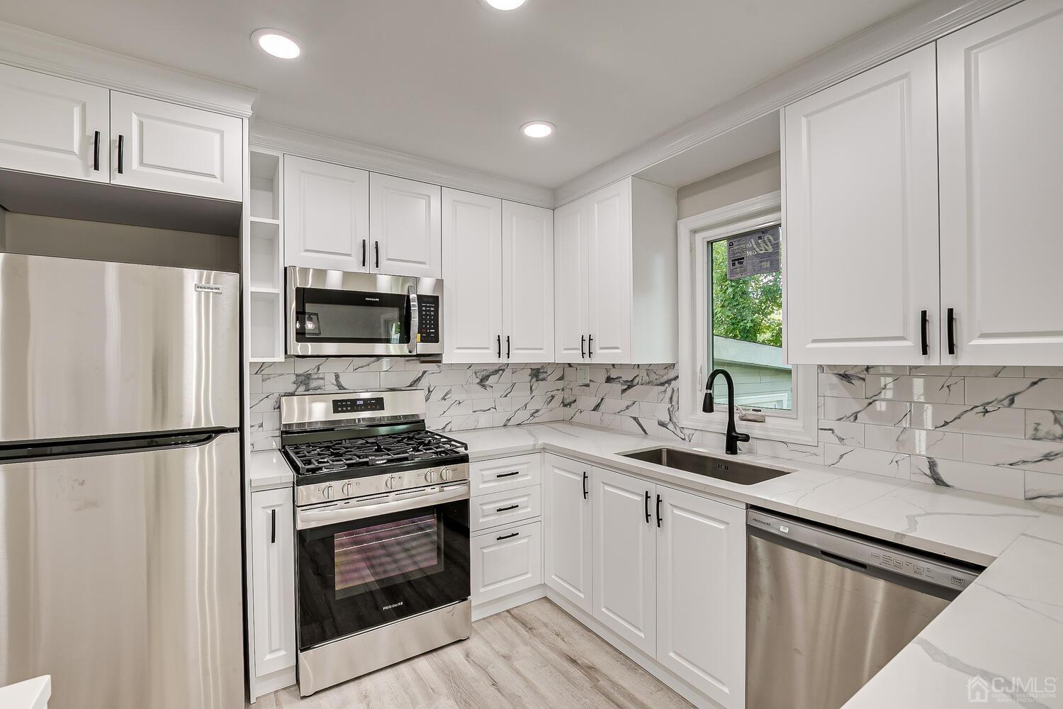8 Amman Road Edison, NJ 08817 - Photo 24 of 39 a kitchen with granite countertop a sink stove and refrigerator