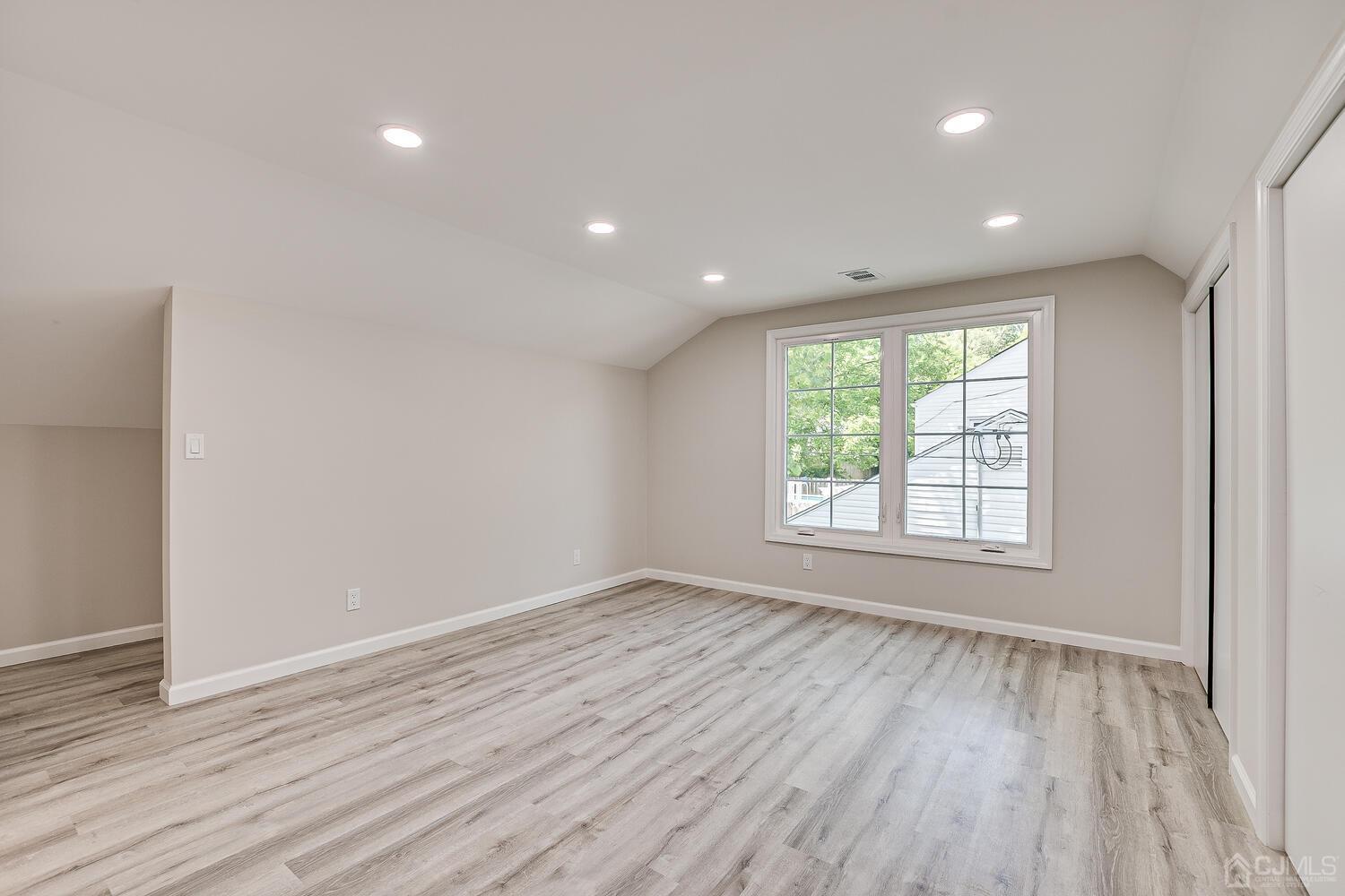 8 Amman Road Edison, NJ 08817 - Photo 26 of 39 an empty room with wooden floor and windows