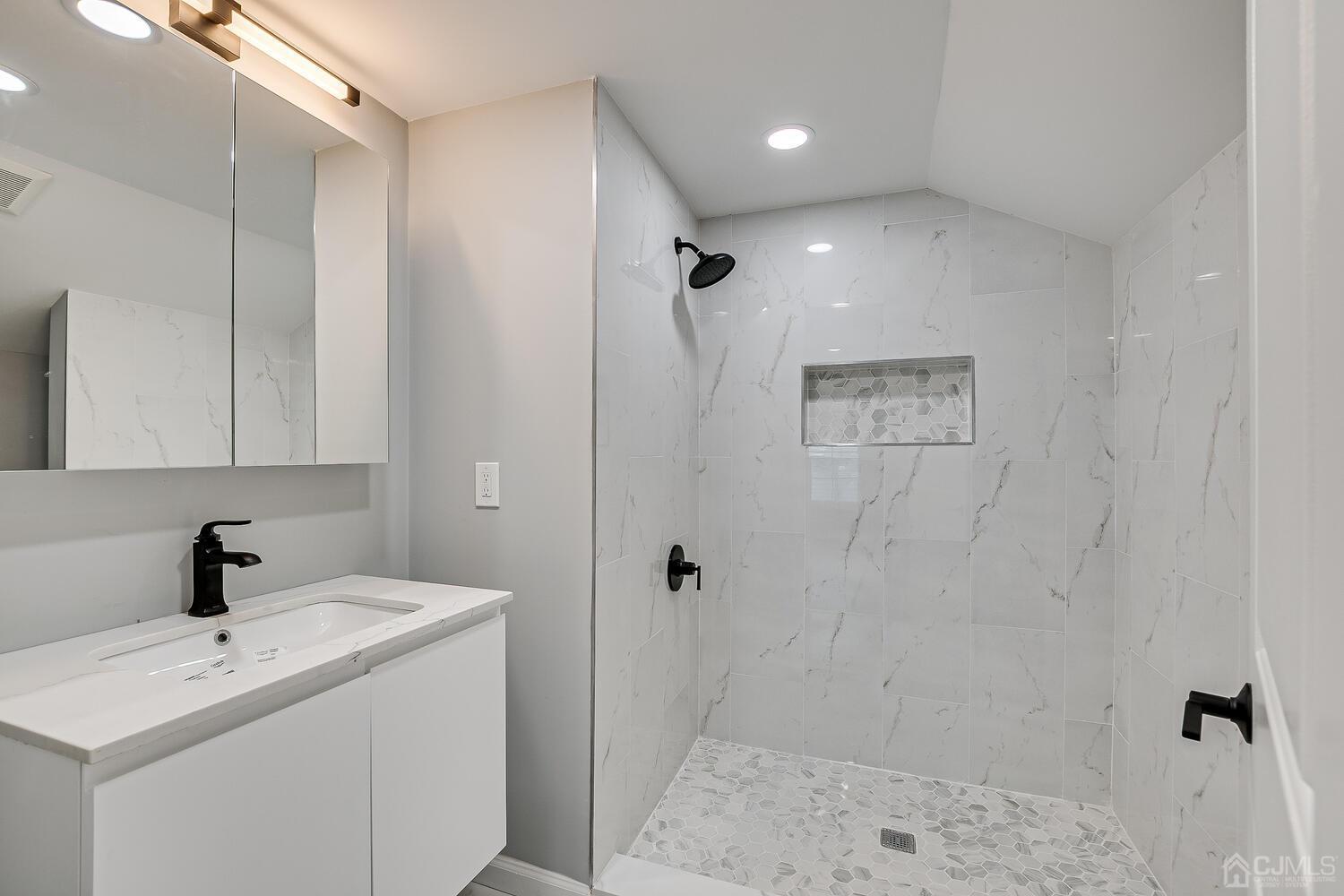 8 Amman Road Edison, NJ 08817 - Photo 29 of 39 a bathroom with a sink a toilet and shower