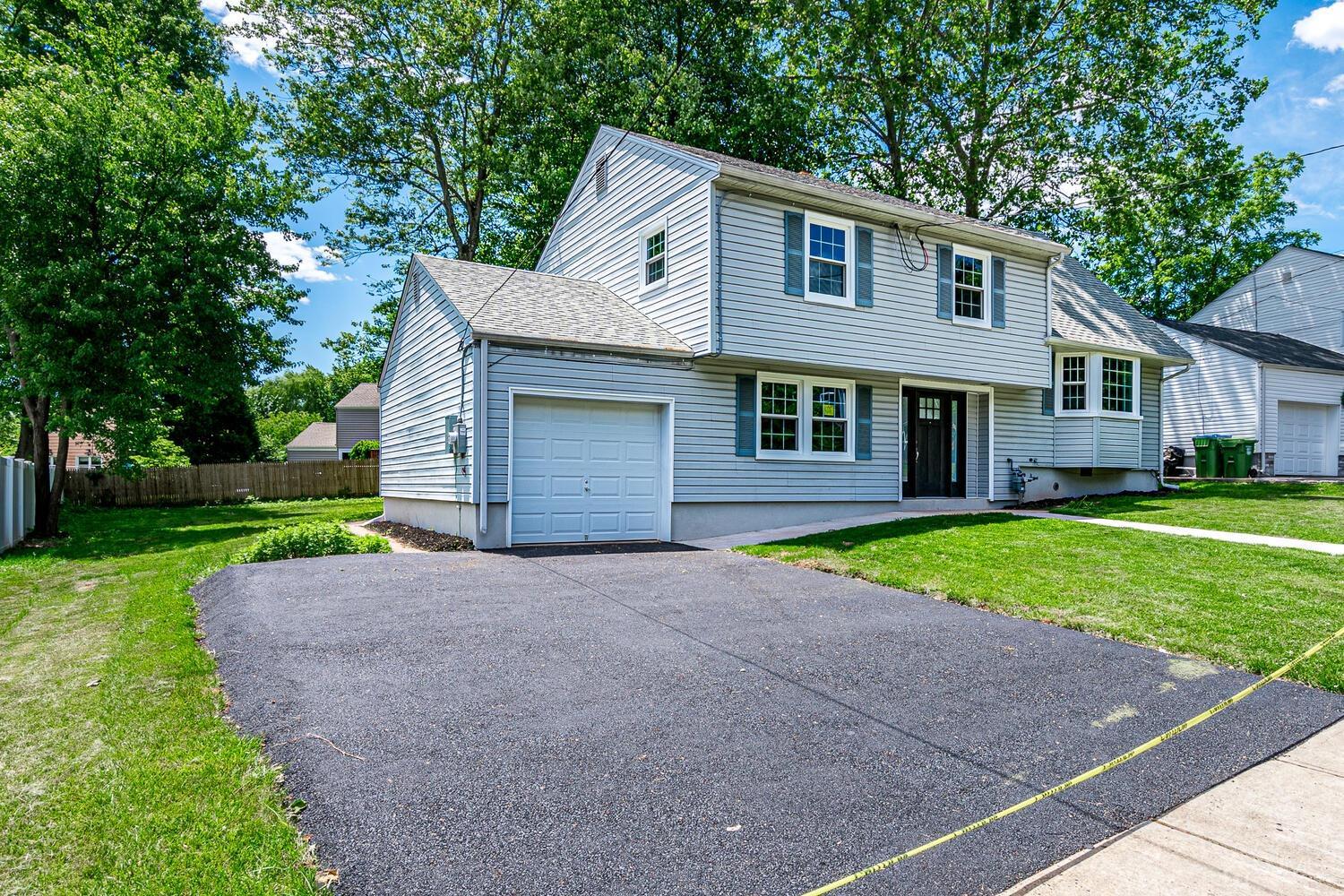 8 Amman Road Edison, NJ 08817 - Photo 3 of 39 a front view of a house with a yard and garage