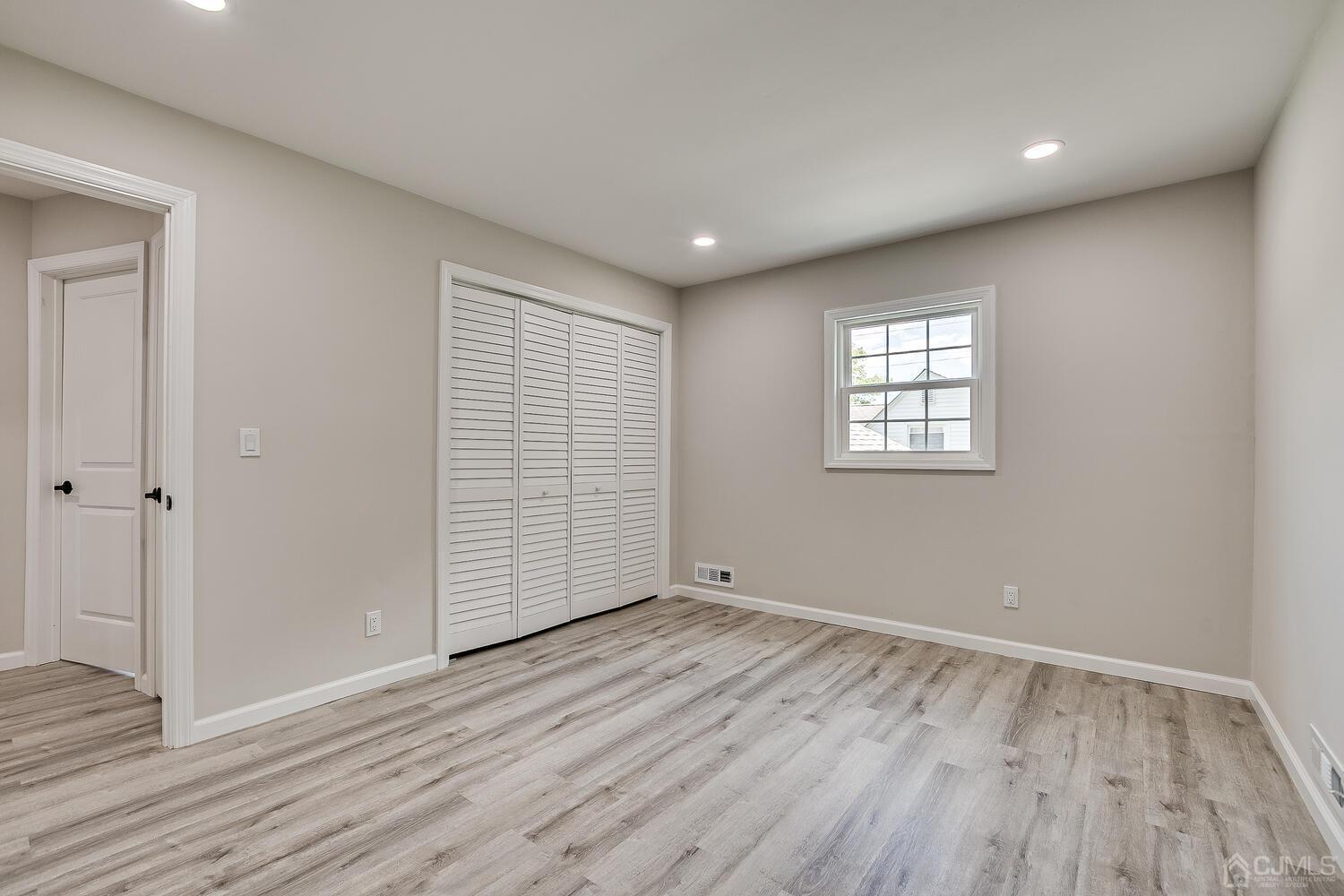 8 Amman Road Edison, NJ 08817 - Photo 31 of 39 a view of an empty room with wooden floor and a window