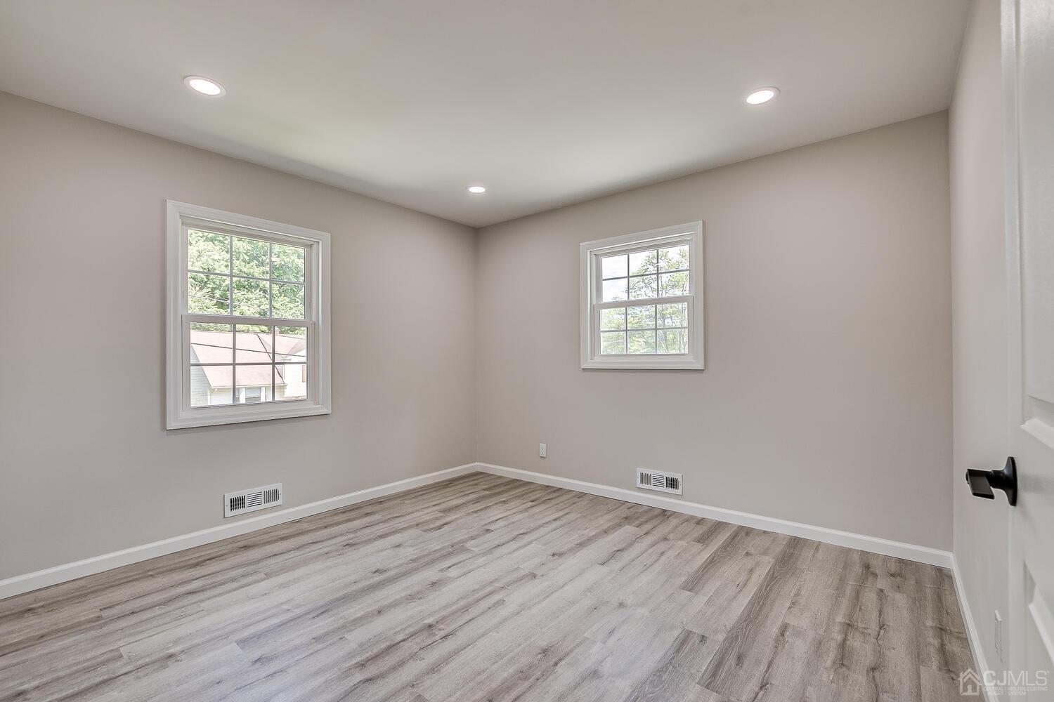 8 Amman Road Edison, NJ 08817 - Photo 32 of 39 an empty room with wooden floor and windows