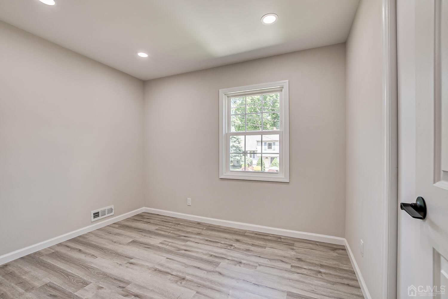 8 Amman Road Edison, NJ 08817 - Photo 34 of 39 an empty room with wooden floor and windows