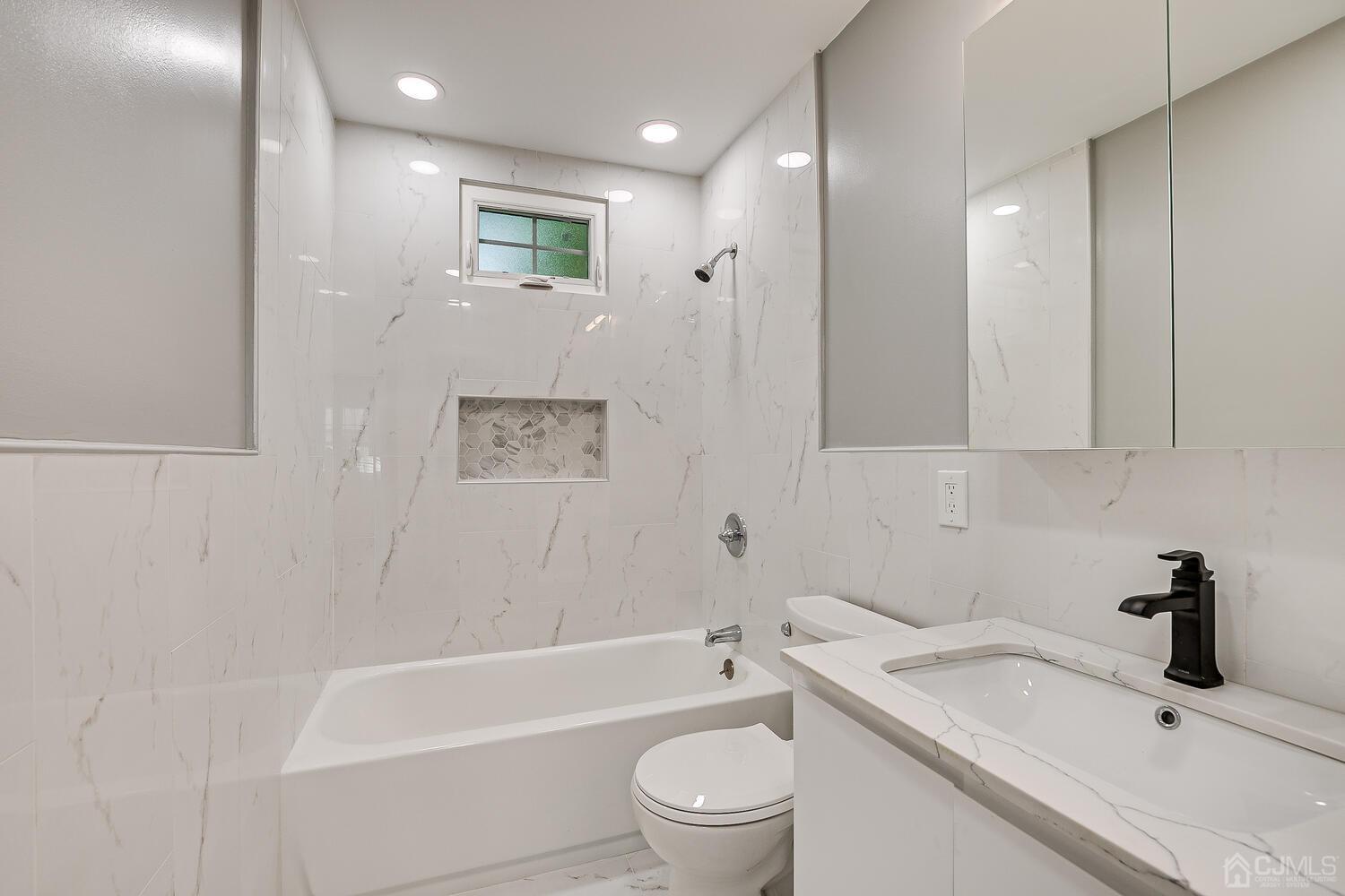 8 Amman Road Edison, NJ 08817 - Photo 36 of 39 a bathroom with a granite countertop sink toilet and bathtub