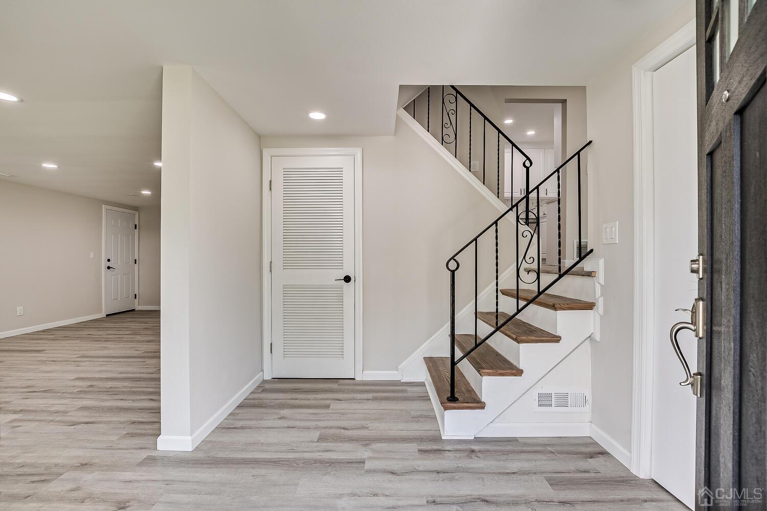 8 Amman Road Edison, NJ 08817 - Photo 8 of 39 a view of entryway and hall with wooden floor