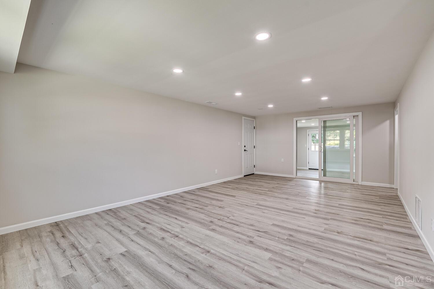 8 Amman Road Edison, NJ 08817 - Photo 10 of 39 a view of an empty room with wooden floor and a window