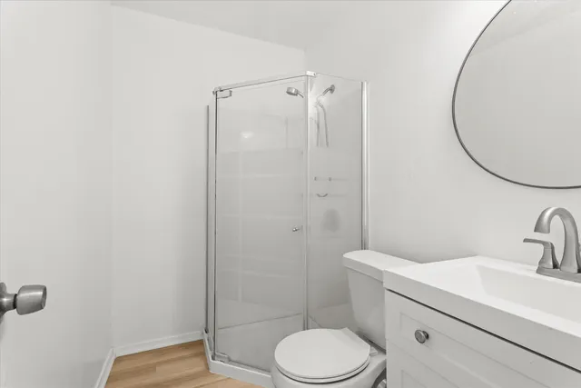 a bathroom with a toilet a sink and shower