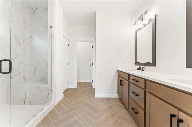 a bathroom with a double vanity sink a mirror and a bathtub