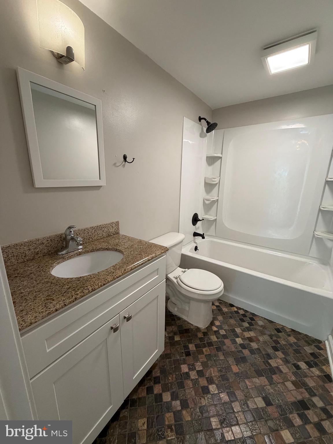 146 Trillium Trail Road Linden, VA 22642 - Photo 19 of 21 a bathroom with a granite countertop sink toilet a mirror and shower