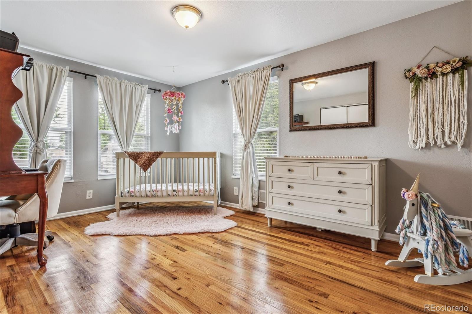 4844 Scranton Court Denver, CO 80239 - Photo 11 of 25 a view of a bedroom with furniture window and wooden floor