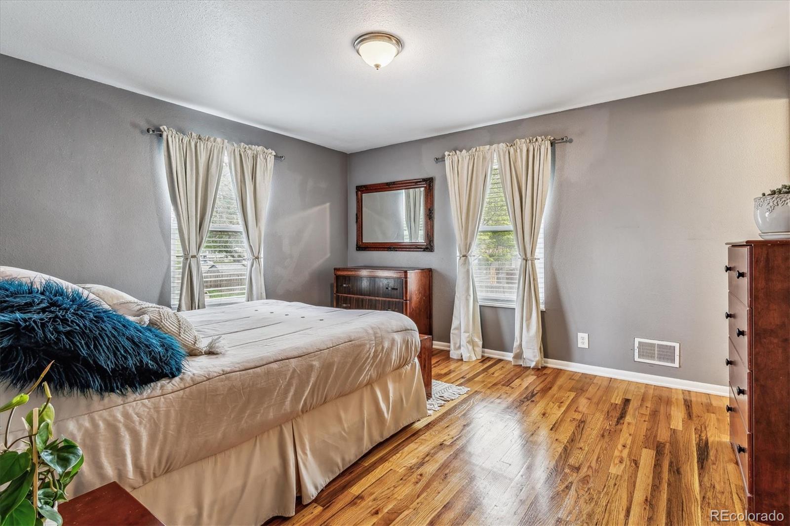 4844 Scranton Court Denver, CO 80239 - Photo 14 of 25 a bedroom with a large bed and a window