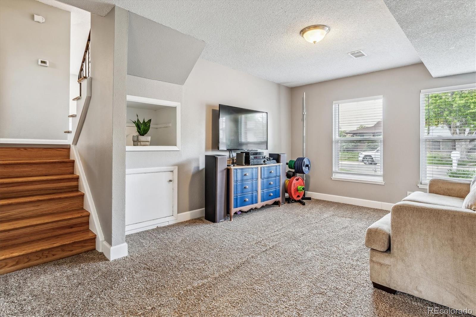 4844 Scranton Court Denver, CO 80239 - Photo 17 of 25 a view of a livingroom with furniture and staircase