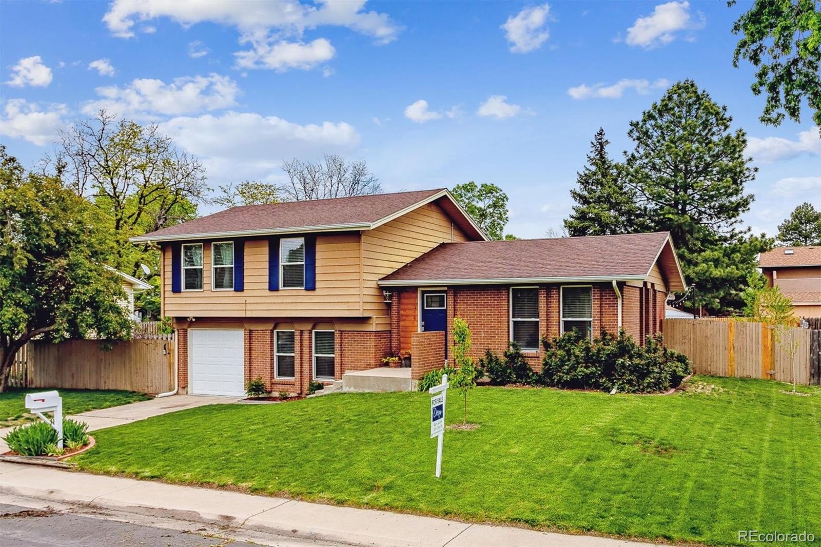 4844 Scranton Court Denver, CO 80239 - Photo 19 of 25 front view of a house with a yard