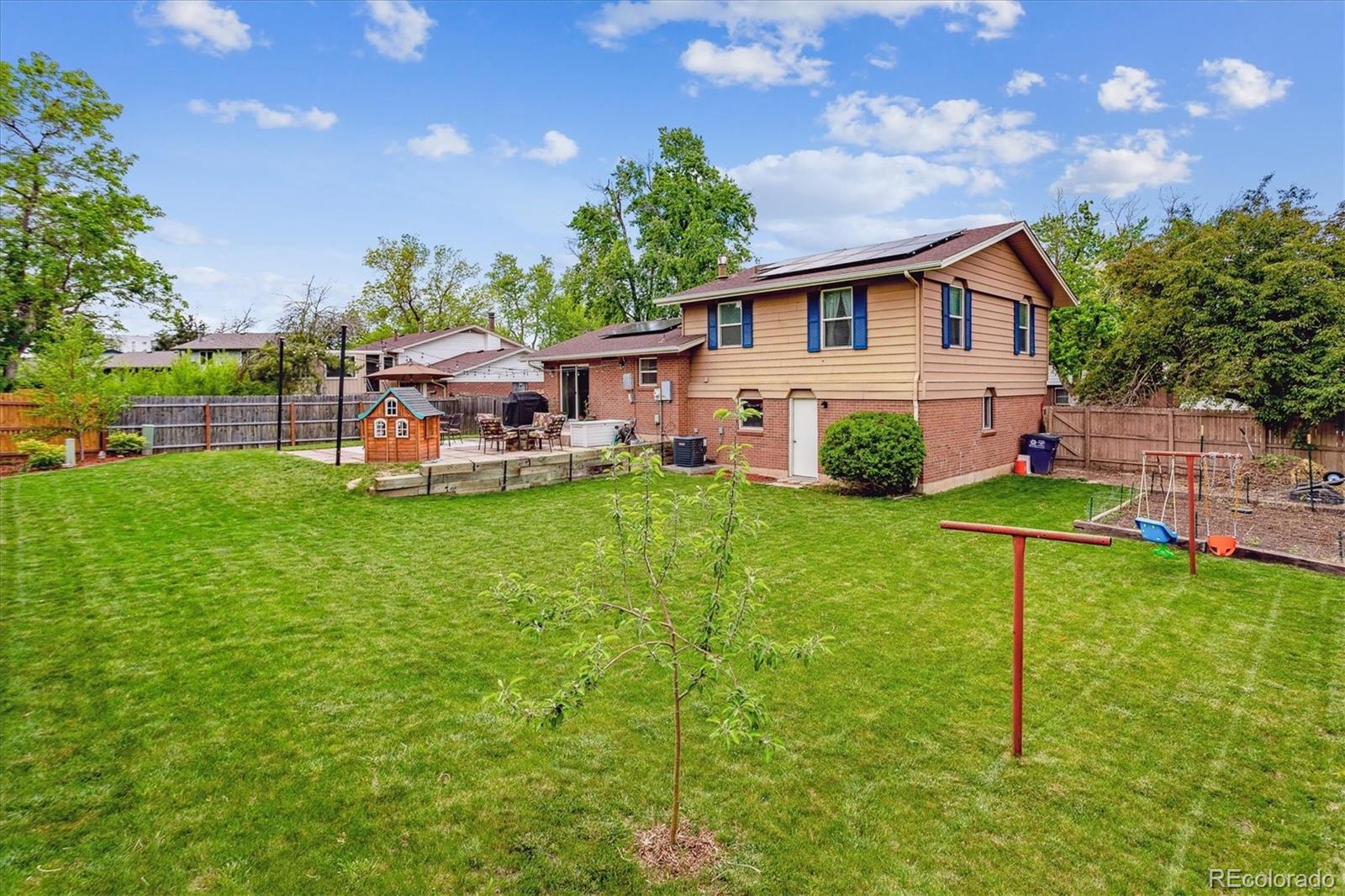 4844 Scranton Court Denver, CO 80239 - Photo 21 of 25 a view of a house with a yard porch and sitting area