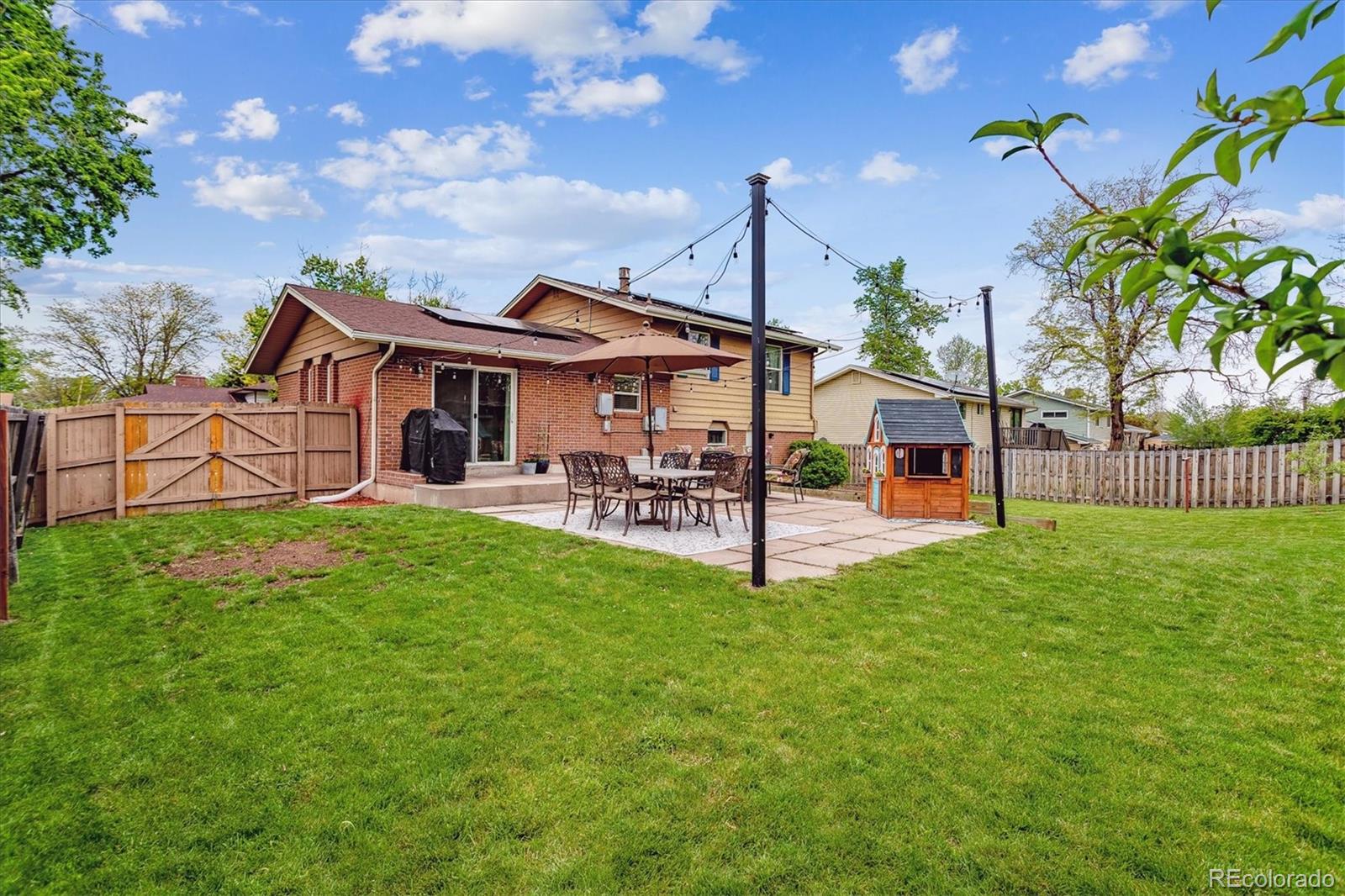 4844 Scranton Court Denver, CO 80239 - Photo 23 of 25 a view of a house with a yard porch and sitting area