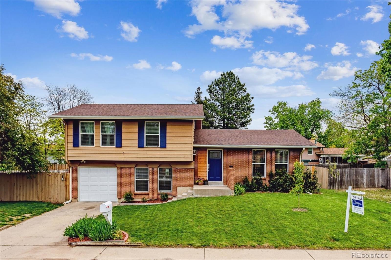 4844 Scranton Court Denver, CO 80239 - Photo 24 of 25 a front view of a house with a yard
