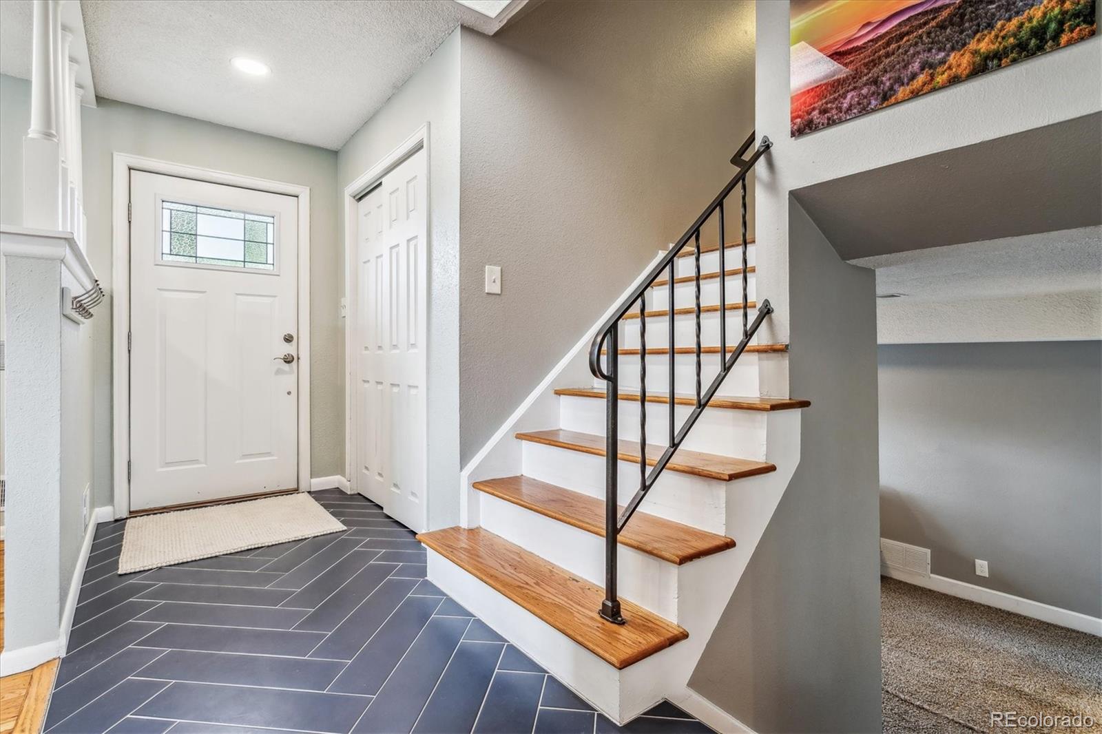 4844 Scranton Court Denver, CO 80239 - Photo 3 of 25 a view of entryway bedroom and hall with wooden floor