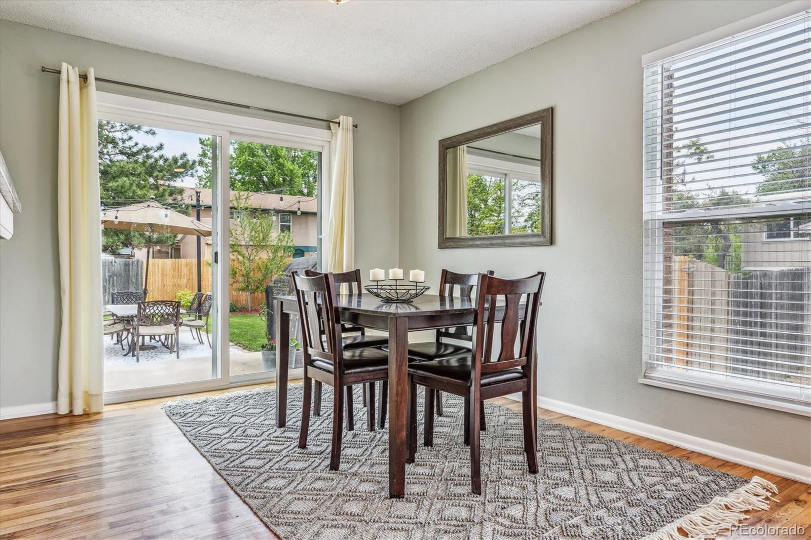 4844 Scranton Court Denver, CO 80239 - Photo 4 of 25 a view of a dining room with furniture window and wooden floor