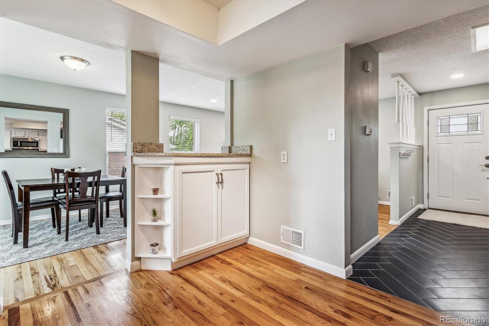 4844 Scranton Court Denver, CO 80239 - Photo 7 of 25 a view of a dining room with furniture window and wooden floor